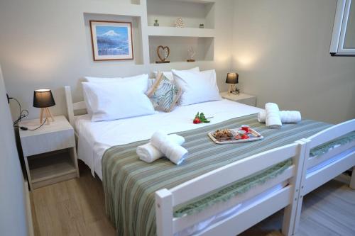 a bedroom with a bed with a tray of food on it at Villa Optasia Scenic Eco Home w private pool in Krousón