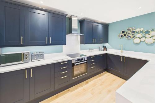 a kitchen with navy blue cabinets and white counter tops at Host & Stay - The Georgian Quarter at Catharine House in Liverpool