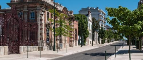 an empty street in front of a brick building at The Brut Case - Avenue de Champagne in Épernay
