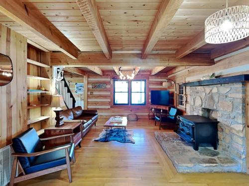 a living room with a stone fireplace in a cabin at Easy Breezie 