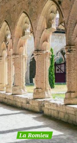 a building with two columns with statues on it at Monette in Condom