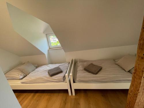 a bedroom with two beds in a attic at Stadtmitte mit Schlossblick! in Sigmaringen