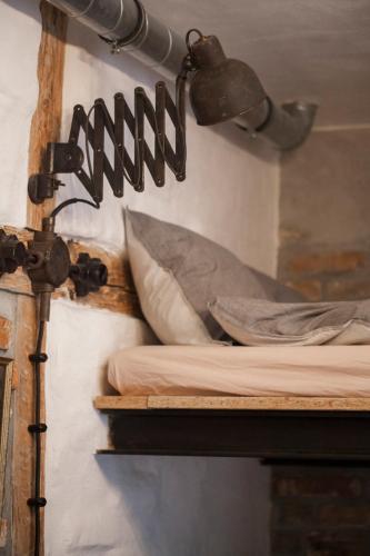 a room with shelves with pillows and a sign on the wall at Apartament by the cathedral in Lublin