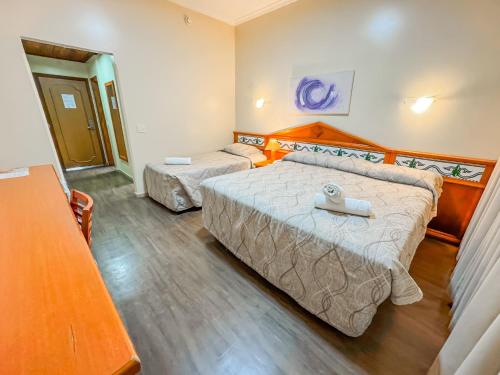 a bedroom with two beds in a room at Hotel Nacional Inn Campos do Jordão in Campos do Jordão