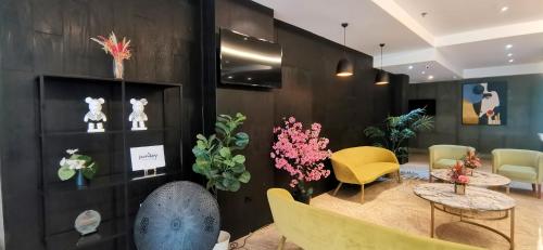 a room with a table and chairs and flowers at Sunday Hevea Hotel and Resort in Angeles