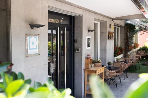 a patio with chairs and tables on a building at Tres Torres Atiram Hotel in Barcelona