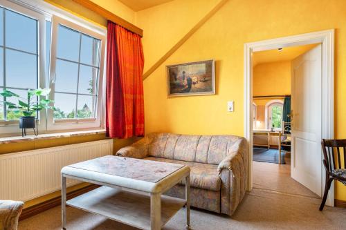 a living room with a couch and a table at Gästehaus Ziegler in Neuenkirchen