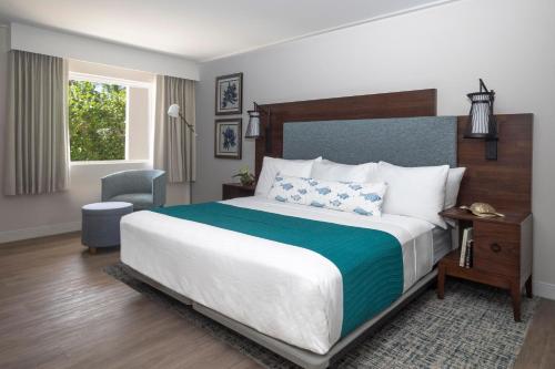 a bedroom with a large bed and a chair at Sanibel Island Beach Resort in Sanibel