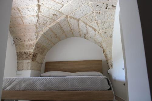 a bedroom with a bed with a stone ceiling at CRISTALLI Home in Galatina