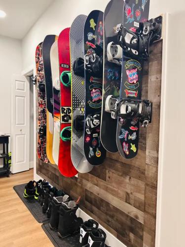 a bunch of snowboards hanging on a wall at Spacious Central 4BR, Ski & Bike in Rutland