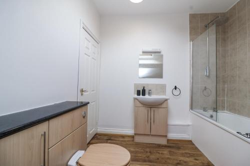 a bathroom with a sink and a shower and a toilet at The Cottage in Clevedon