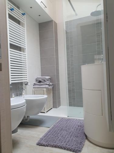 a bathroom with a toilet and a sink and a shower at Antico Borgo Fonzaso in Fonzaso