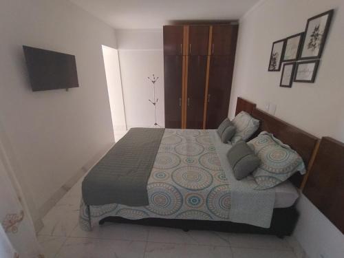 a bedroom with a bed with pillows on it at Spectacular apartment 202C - 7 thermal pools in Caldas Novas