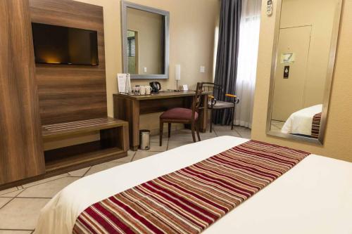 a hotel room with a bed and a desk at Premier Hotel The Richards in Richards Bay