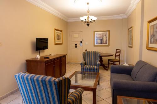 a living room with a couch and a table at Premier Hotel The Richards in Richards Bay