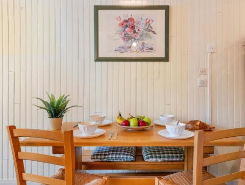a wooden table with a bowl of fruit on it at Residence Hauts de Chaviere In Val Thorens, Ski In-Out with WiFi in Val Thorens