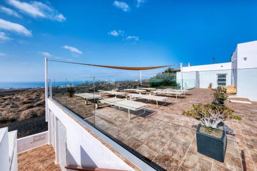 a patio with a view of the ocean at Casa Serena 10 Boutique- Adults Only-Breakfast Included in Mácher