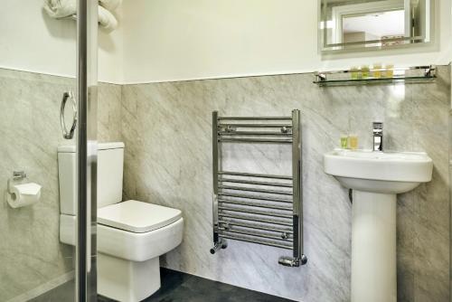 a bathroom with a toilet and a sink at Finest Retreats - Kelsick Villa Guest House - Helvellyn in Ambleside