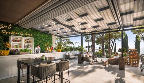 a rendering of a restaurant with a table and chairs at Remisens CASA ROSA - Hotel Metropol Annexe in Portorož