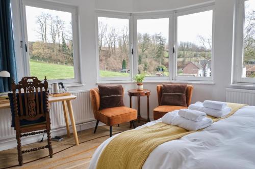 Postel nebo postele na pokoji v ubytování Geulzicht Hotel