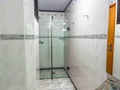 a shower with a glass door in a bathroom at Hotel Nacional Inn Campos do Jordão in Campos do Jordão