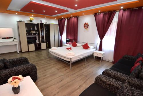 a living room with a bed and two couches at Casa Ali in Costinesti