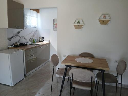 a kitchen with a table and chairs in a kitchen at Sunny Guest House in Gjirokastër