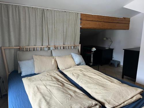 a bedroom with a large bed with pillows at Tauglerei Appartement Vogelbeere in Sankt Koloman