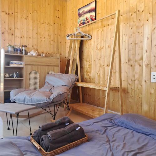 a room with two beds and a ladder and a shelf at Bee Home Di Linh in Di Linh