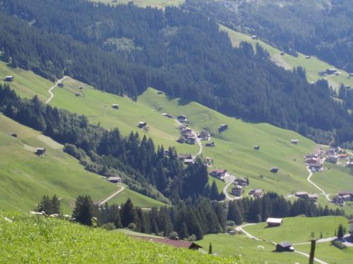 a view of a green valley with houses and trees at Haus Leonhard in Tux