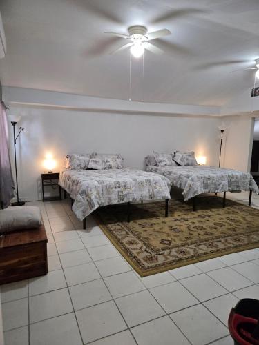 a bedroom with two beds and a ceiling fan at Midtown Guest House in Mobile
