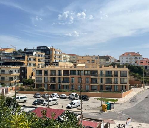 a parking lot with cars parked in front of buildings at Heart Stone by the Sea in Lourinhã