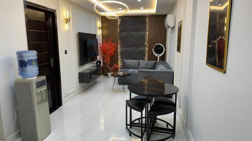 a living room with a couch and a table at Luxury Private Top Floor Apartment in Heart of Bahria Town in Lahore