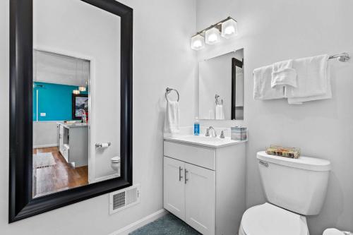 a bathroom with a toilet and a sink and a mirror at New The Pool Loft at Poplar Hill in Annapolis