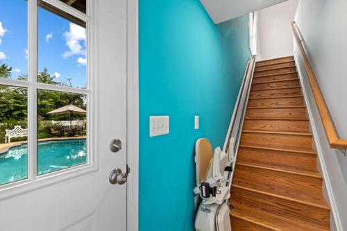a room with a blue wall and stairs next to a pool at New The Pool Loft at Poplar Hill in Annapolis