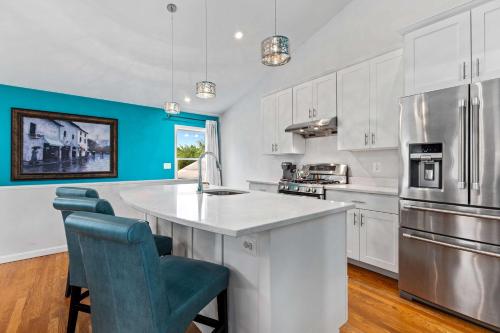 a kitchen with white cabinets and a white counter top at New The Pool Loft at Poplar Hill in Annapolis