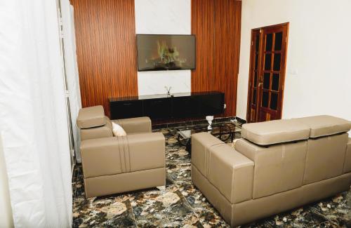 a living room with a couch and chairs and a piano at Senlodge in Dakar