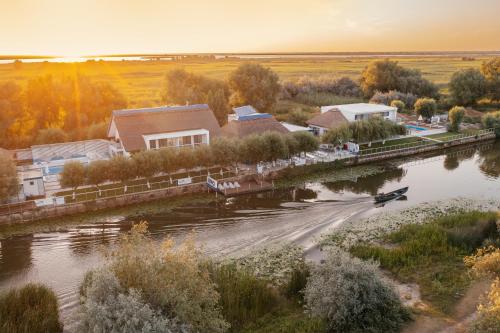 an aerial view of a river with houses and a boat at WPO - WILD PIKE OASIS in Caraorman