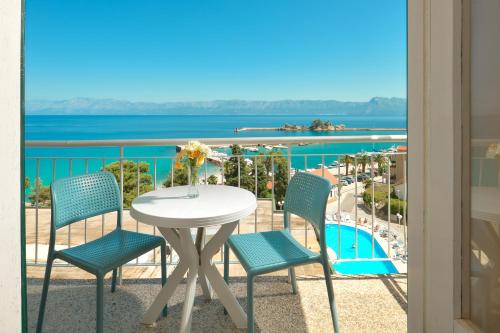 a table and chairs on a balcony with a view of the ocean at Hotel Faraon in Trpanj
