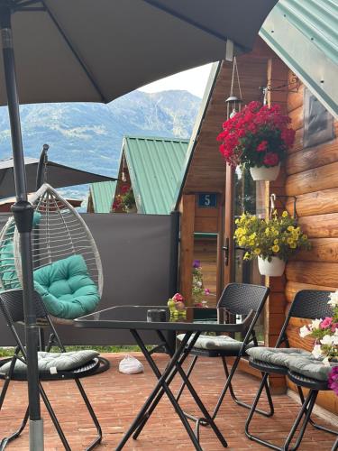 a patio with a hammock and a table and chairs at Camp Laksi in Plav