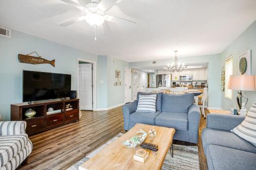a living room with two couches and a tv at Charleston Oceanfront Villas 101 in Folly Beach