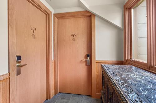 a room with a bed and a door with a window at von Trapp Family Lodge & Resort in Stowe