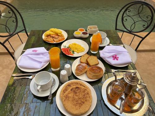 a table topped with plates of breakfast foods and drinks at Riad Timija in Marrakech