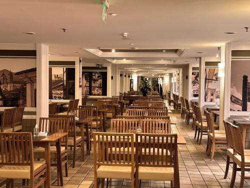 a row of tables and chairs in a restaurant at Kubitschek Plaza Hotel in Brasilia