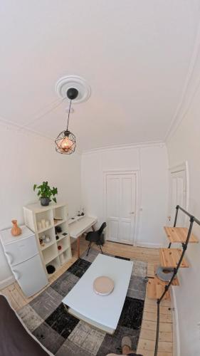 a white room with a desk and a table at Nordhavn Cozy Room in shared apartment in Copenhagen