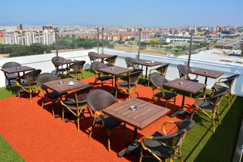 a group of tables and chairs on a roof at Adranos Hotel in Bursa