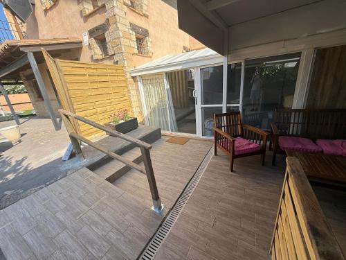 a porch with a bench and a table and chairs at Hotel Rural Los Abriles in El Toro