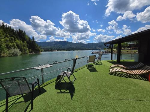 a deck with chairs and a view of a river at Echilibru in Colibiţa