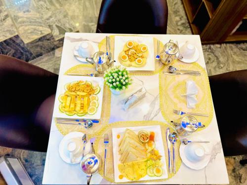 a table with plates of food on it at PRESKEN WHITE HOUSE in Lagos