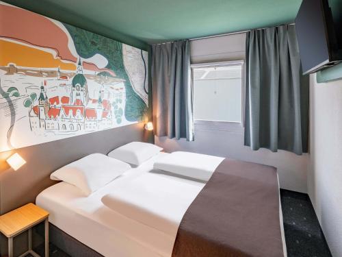 Ένα ή περισσότερα κρεβάτια σε δωμάτιο στο B&B HOTEL Hannover-Garbsen